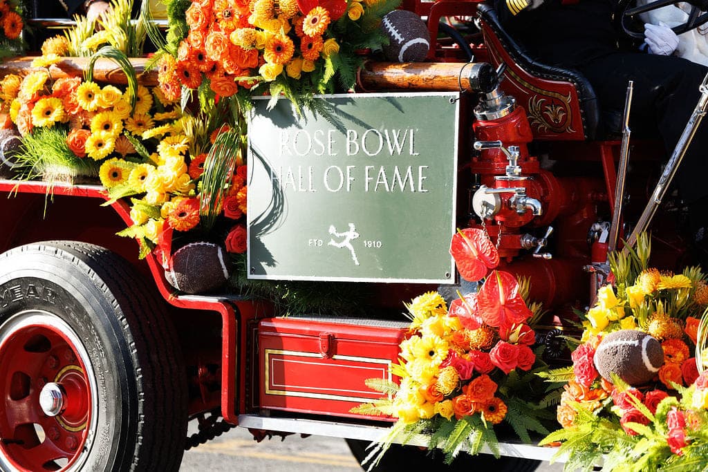 Marigolds and anthurium banked across a vintage fire engine at the Rose Parade